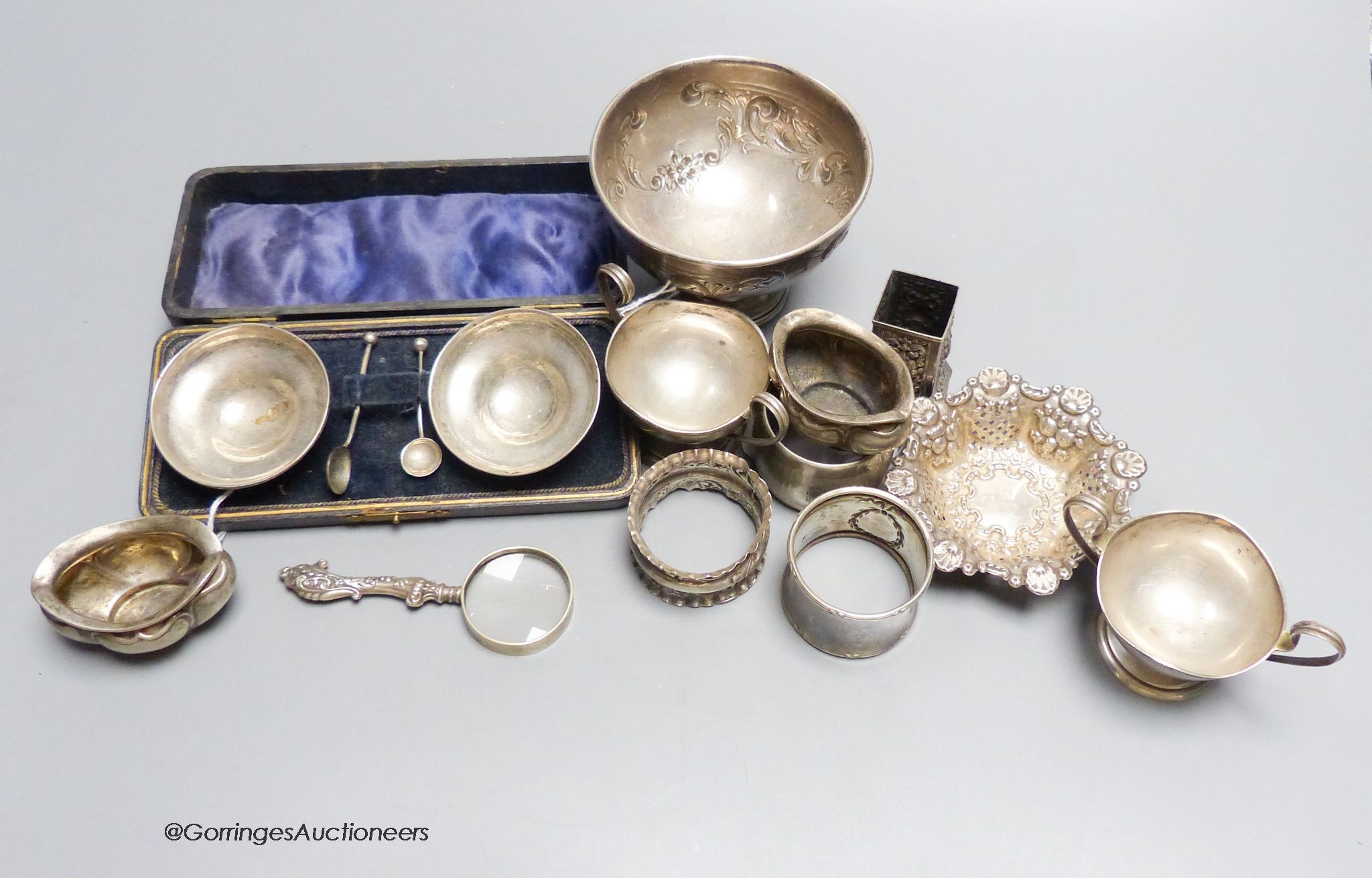 A pair of silver salts (cased), another pair of footed salts, a bowl, two napkin rings, etc. approximately 11oz. gross